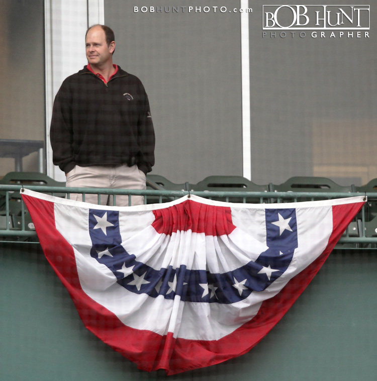 A fan surveys the field from his suite decorated with bunting on opening night for the Peoria Chiefs